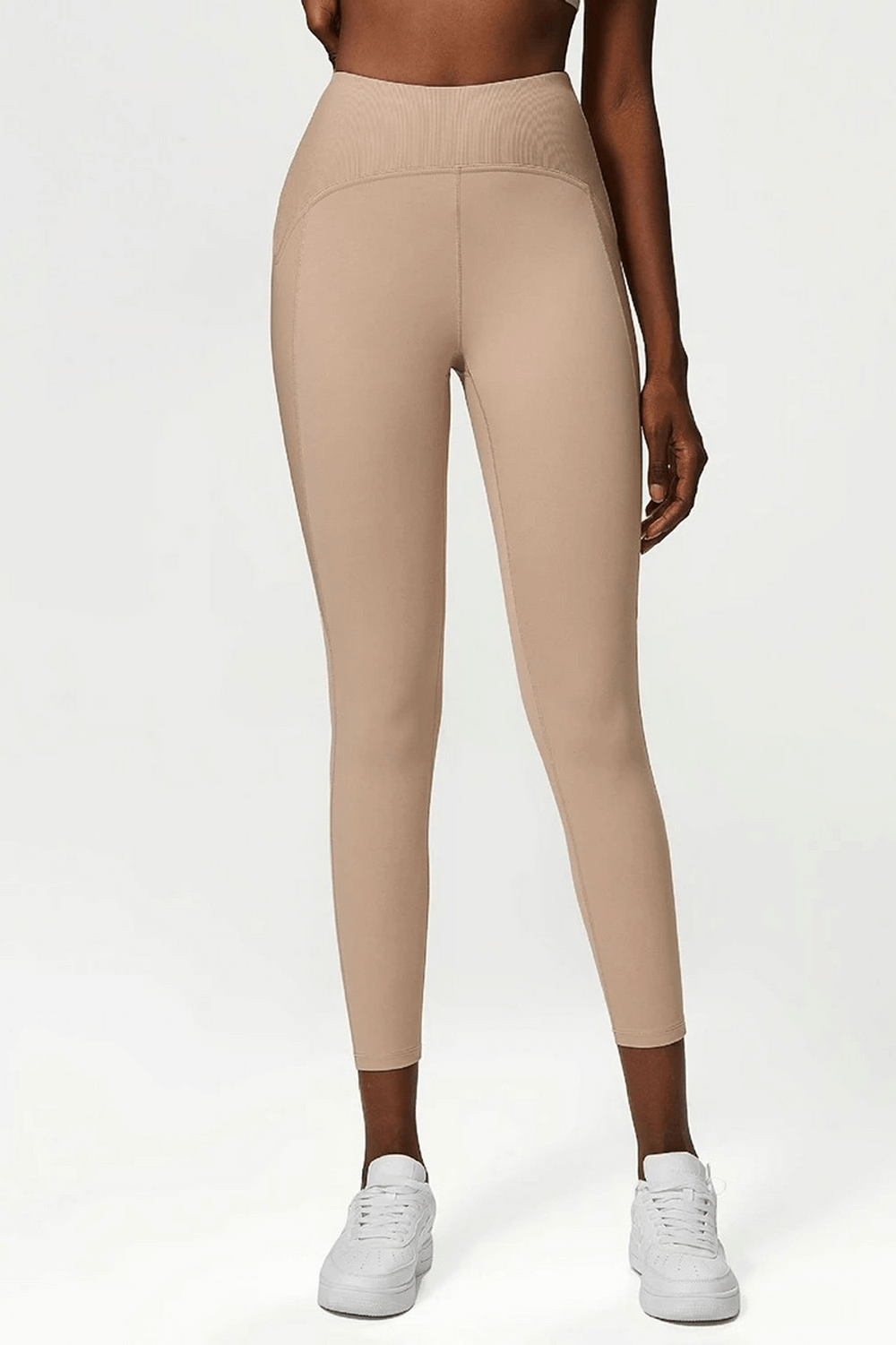 Stylish beige women's nylon-spandex leggings with elastic waistband, ideal for yoga, gym, and dancing. Versatile and seasonal fit.